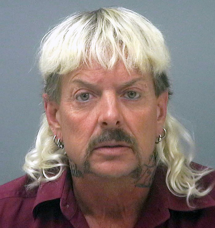 Man with blonde mullet and earrings, related to Tiger King news.