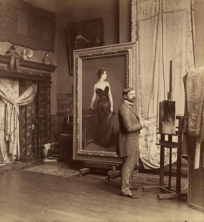 Artist standing in studio with the scandalous painting "Vulgar" at the Metropolitan Museum of Art.