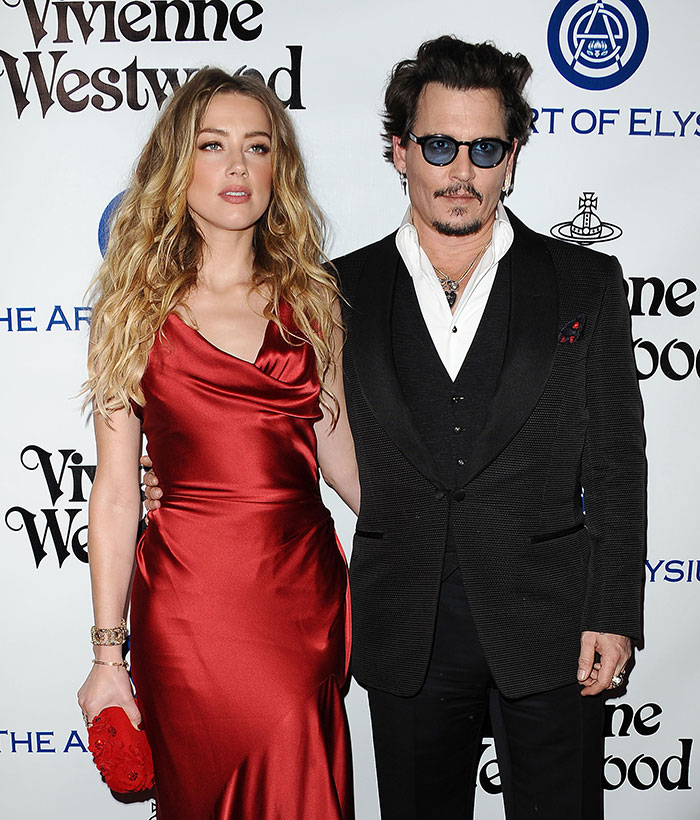 Man with sunglasses and a dark suit at a Vivienne Westwood event, linked to Hollywood return discussion. Man with sunglasses and a dark suit at a Vivienne Westwood event, linked to Hollywood return discussion.