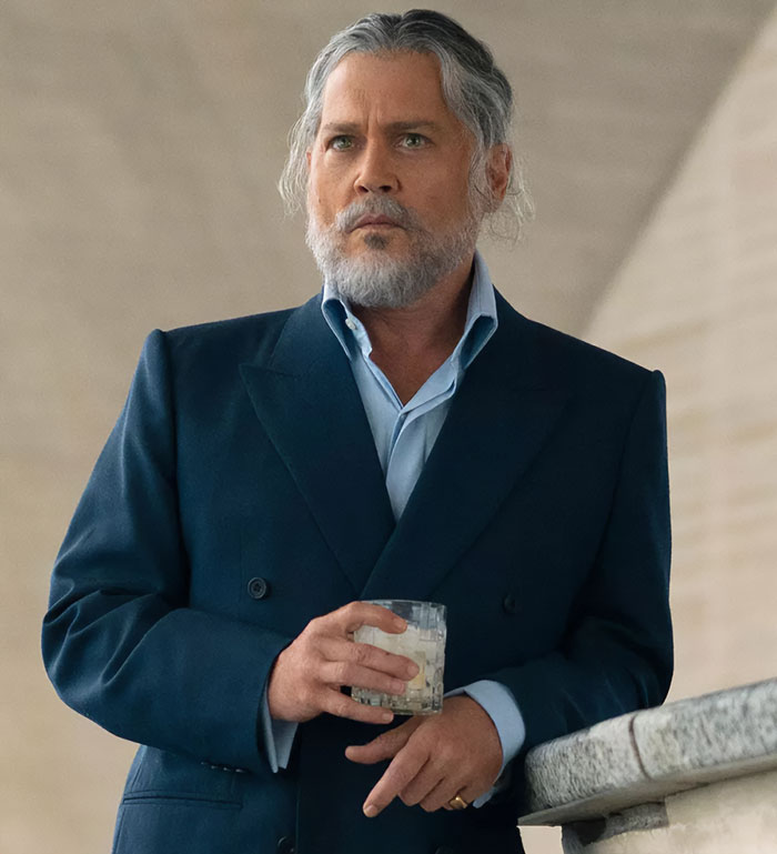 Actor in blue suit holding a glass, representing Hollywood's evolving dynamics. Actor in blue suit holding a glass, representing Hollywood's evolving dynamics.