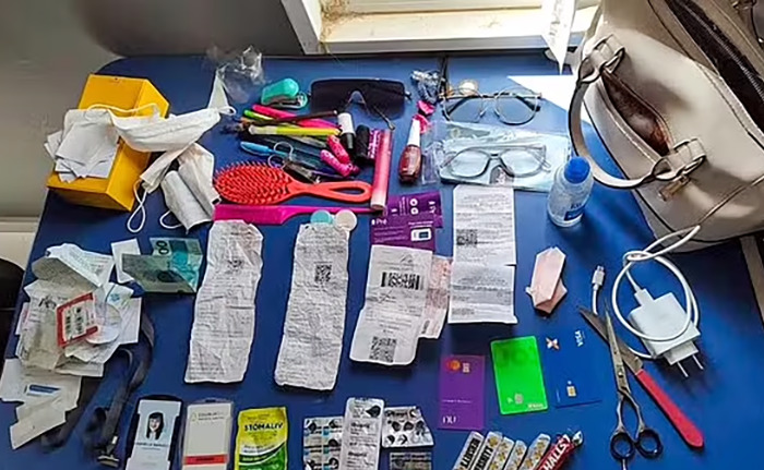 Personal items on a table, including glasses, receipts, cosmetic products, and a handbag, related to a poisoned Easter eggs case. Personal items on a table, including glasses, receipts, cosmetic products, and a handbag, related to a poisoned Easter eggs case.