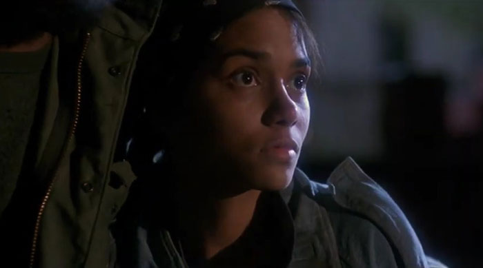 Actress focused in a dimly lit scene, showcasing dedication and commitment to a difficult role in acting.