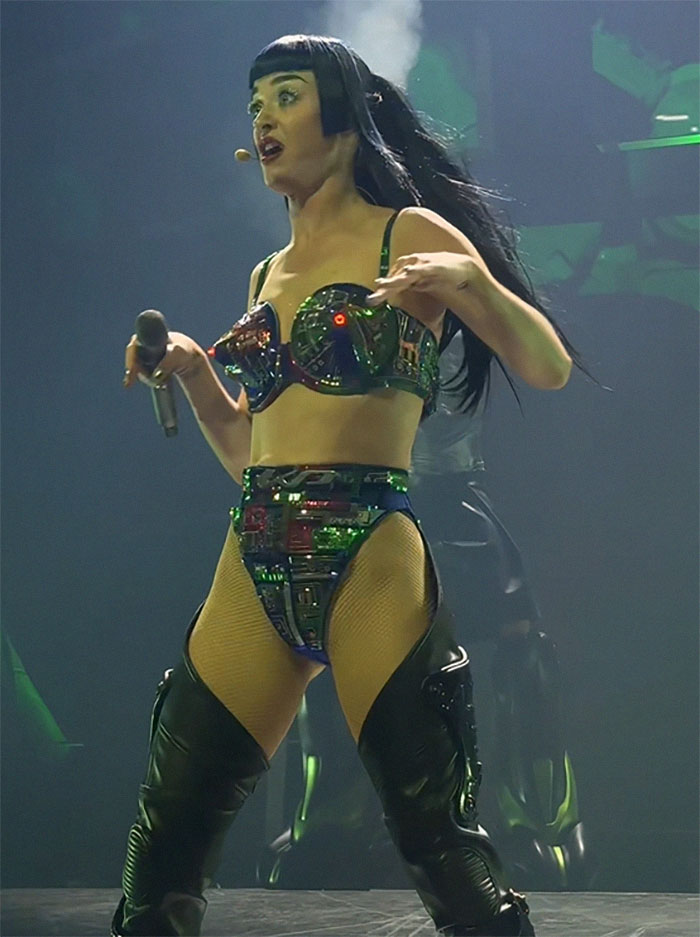 Singer performing on stage in futuristic outfit, captured during tour debut.
