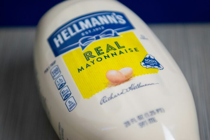 Close-up of Hellmann's mayonnaise bottle on its side.