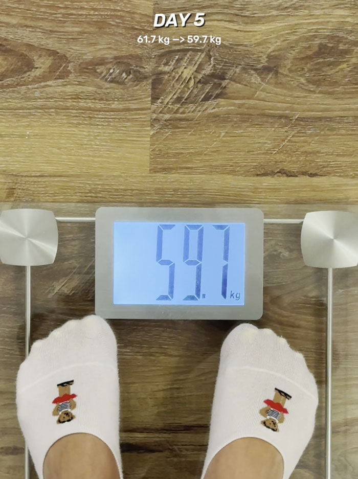 Feet in socks standing on a digital scale showing weight loss, highlighting Switch-On Diet shedding fats and maintaining muscle.