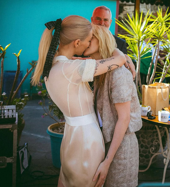 Lovebirds sharing a tender moment in an intimate wedding setting with vibrant outdoor decor.