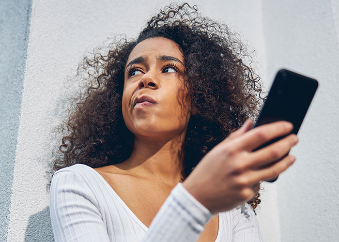 A person holding a phone, looking thoughtful, symbolizing a landlord's secret. A person holding a phone, looking thoughtful, symbolizing a landlord's secret.