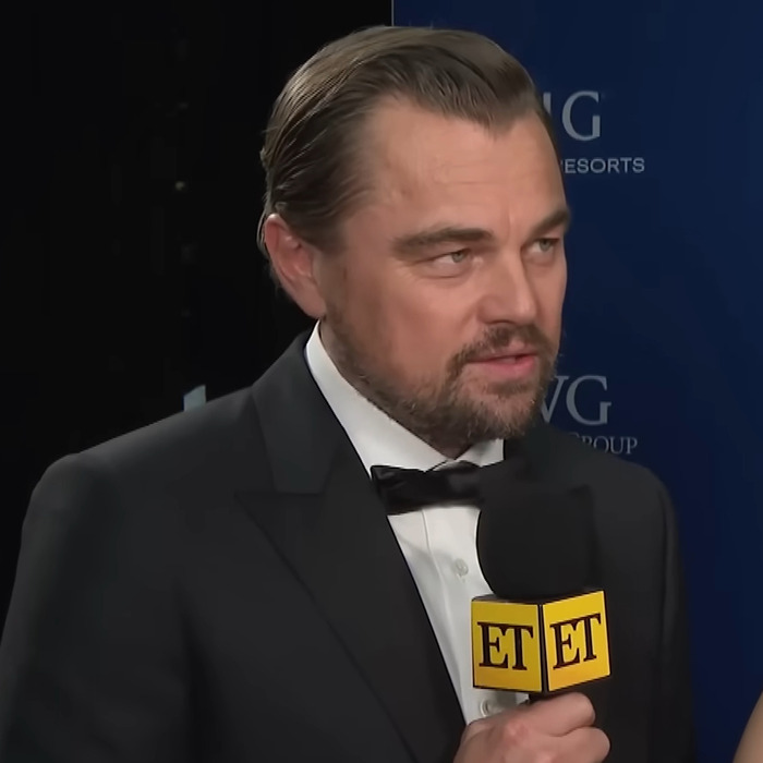 Leonardo DiCaprio at Las Vegas red carpet, showcasing new look, answering questions in a tuxedo.