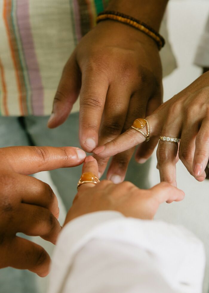 Close-up of diverse hands with rings touching fingertips, symbolizing obvious things you've just become aware of connection.