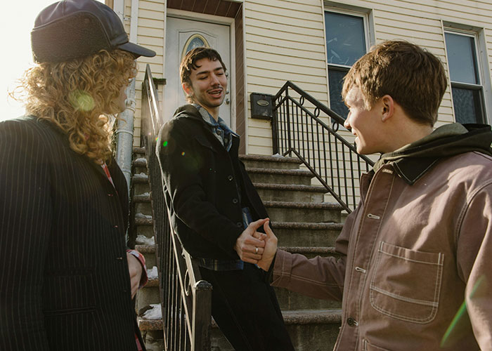 Three people talking on outdoor stairs, displaying potential lifestyle red flags.