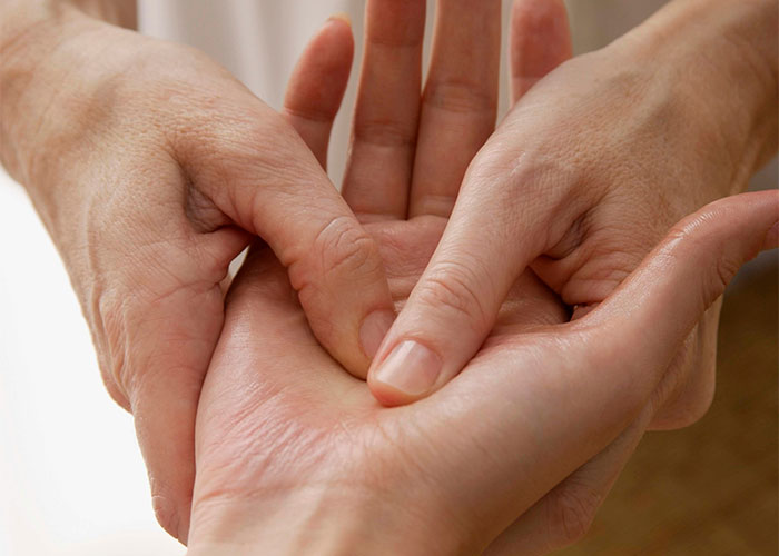 Hands holding and examining a palm, symbolizing lifestyle choices considered as potential red flags.