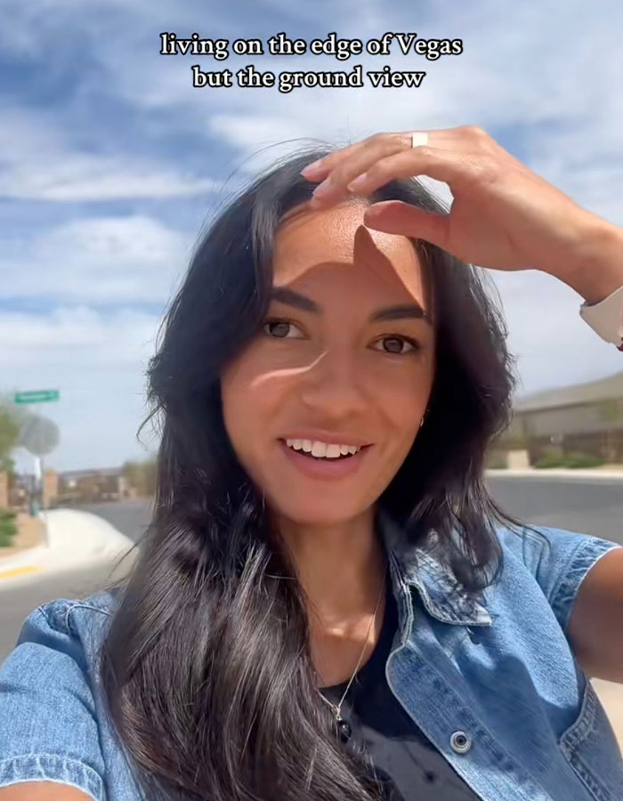 Smiling woman living on the edge of Vegas, cityscape in the background, capturing vibrant TikTok moment.