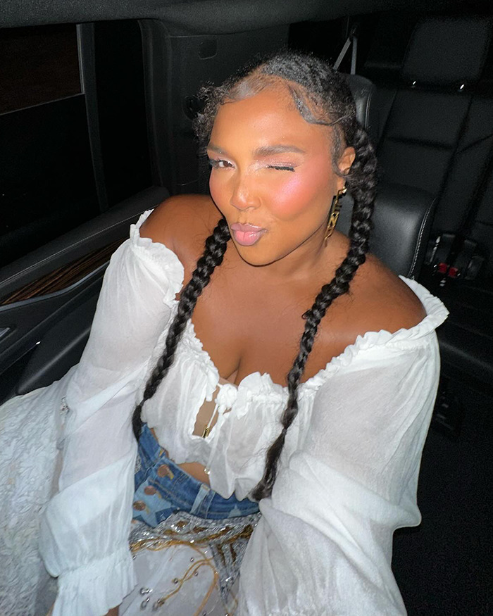 Young woman in a white blouse with braided hair, winking, sitting in a car, illustrating weight loss methods. Young woman in a white blouse with braided hair, winking, sitting in a car, illustrating weight loss methods.