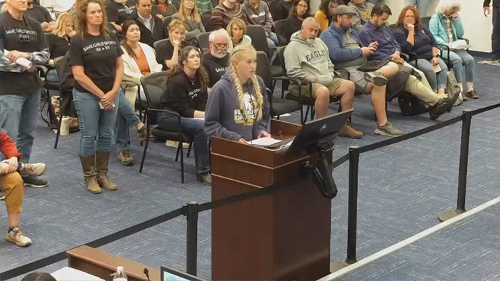 A girl gives testimony on a trans locker room issue at a board meeting, sparking a strong reaction.