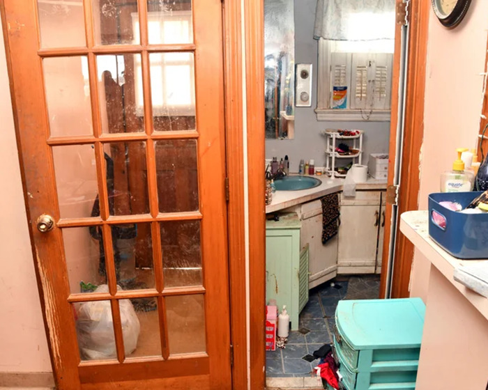 Small, cluttered bathroom signifying captivity.