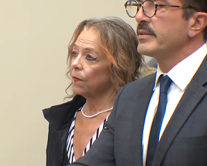 Stepmom in court, wearing striped outfit, related to man held captive for 20 years breaking silence.
