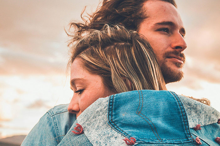 Couple embracing outdoors, illustrating the importance of being present and lessons men learned from their partners.