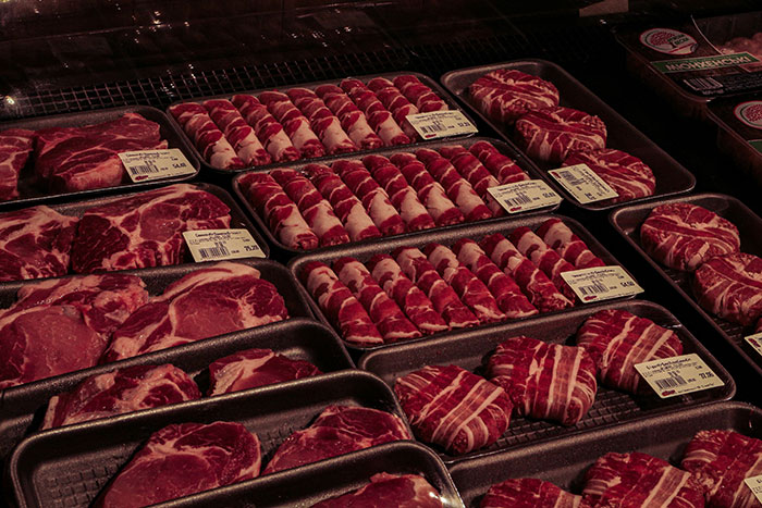 Assorted fresh cuts of meat neatly packaged and displayed, highlighting presence and quality in selection.