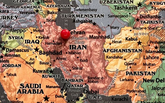 Map of the Middle East featuring a red pin marking Iran; focus on geographic confidence.