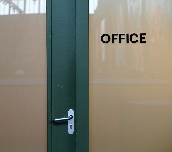 Office door with a green frame and handle, suggesting a setting for adult tantrums remembered vividly.
