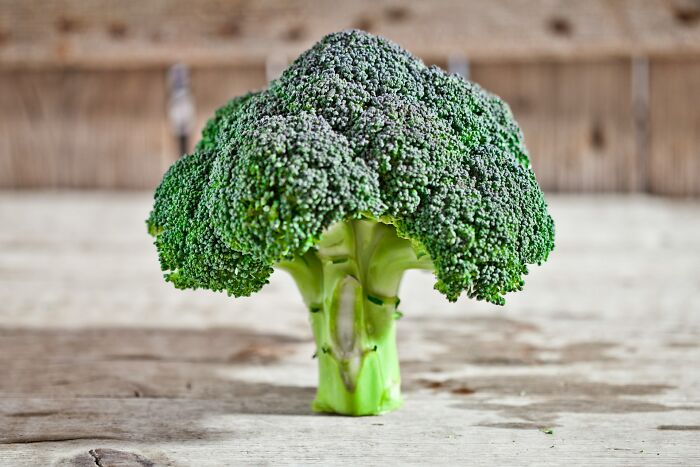 Broccoli on a wooden table, related to disturbing and disgusting doctor findings in patients.