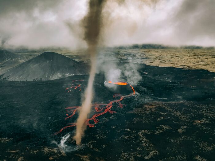 Volcanic eruption with lava flow and smoke; dramatic scene illustrating potential danger from natural forces.