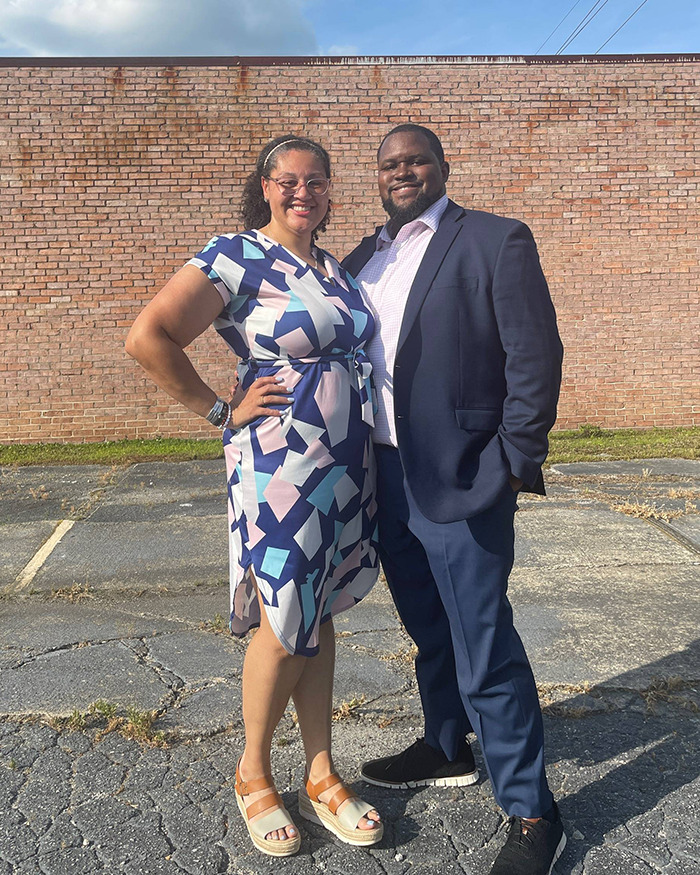 Couple standing outdoors in formal attire, linked to wedding debate over inappropriate guest dress choices.