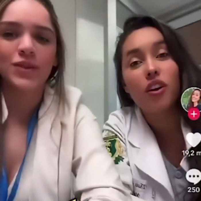 Two med students in white coats during an online apology session after mocking a transplant patient. Two med students in white coats during an online apology session after mocking a transplant patient.