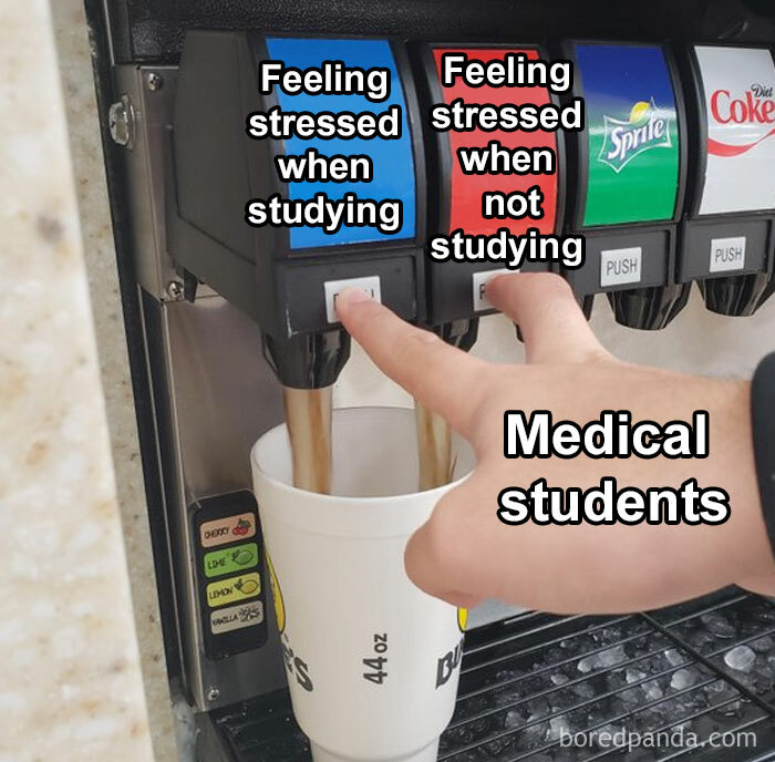A soda machine labeled with stress options as medical students fill a cup, highlighting their constant stress.