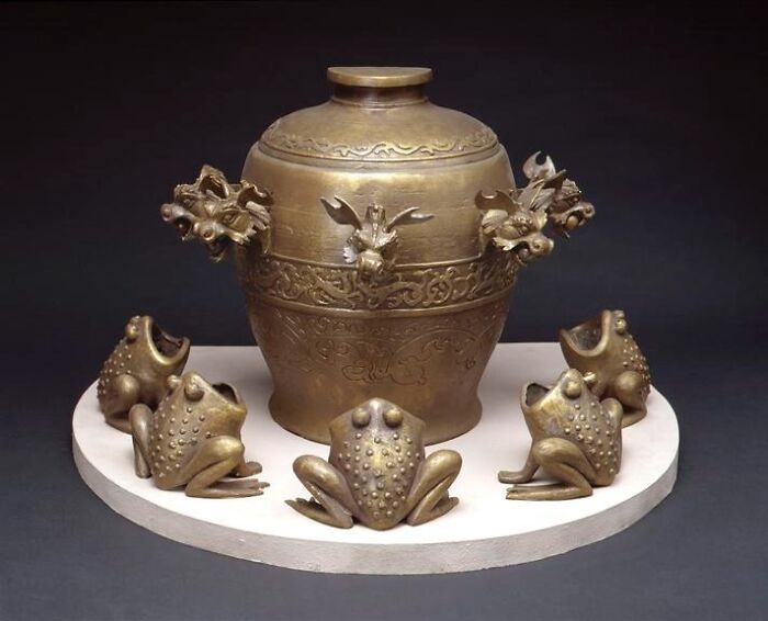 Ancient artifact with intricate designs and frog ornaments, puzzling modern scientists.