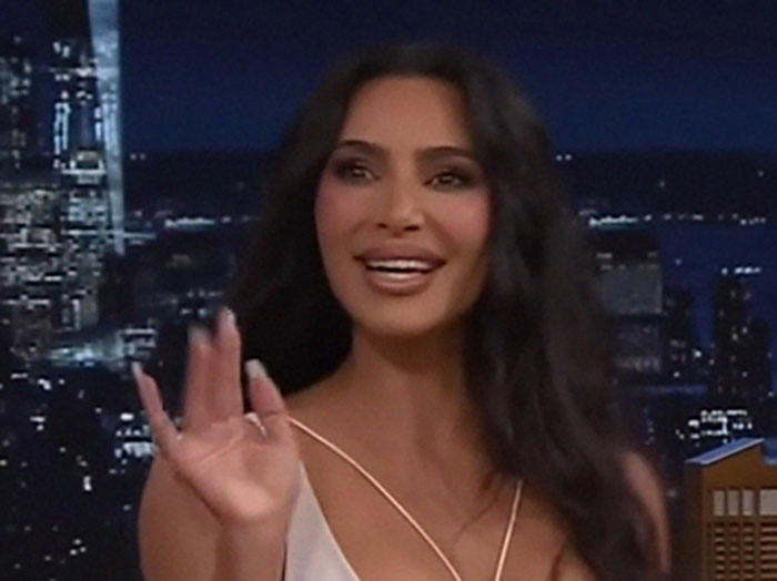 Woman smiling and gesturing on a talk show set, representing a memorable celebrity encounter.