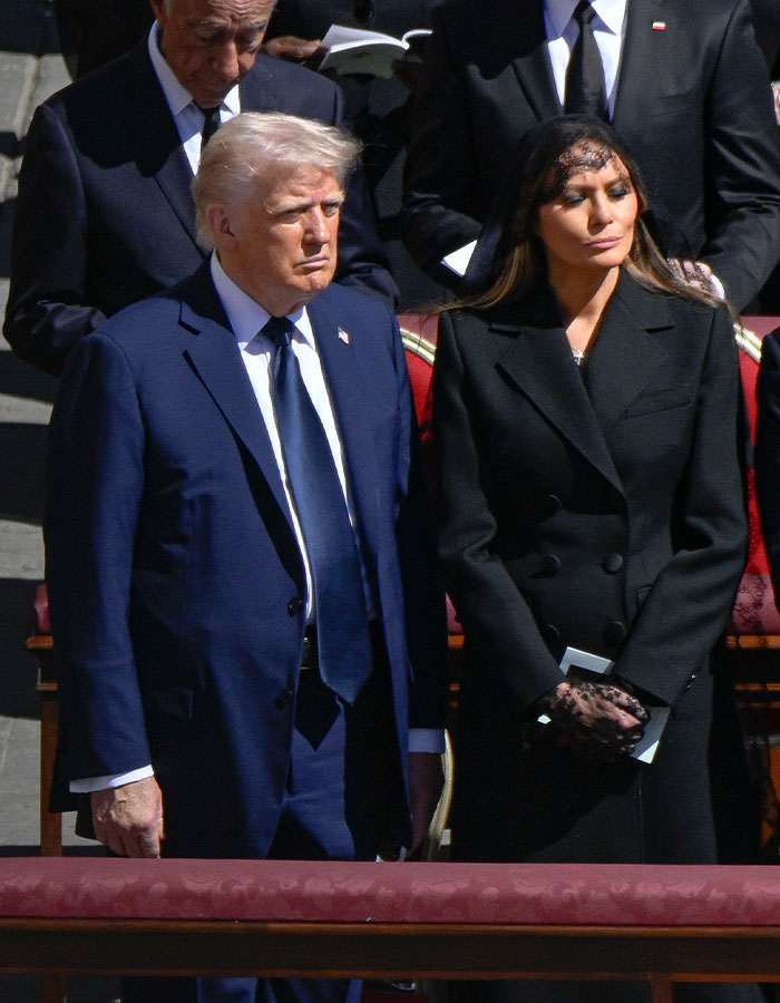 Man and woman in formal attire at an outdoor ceremony.