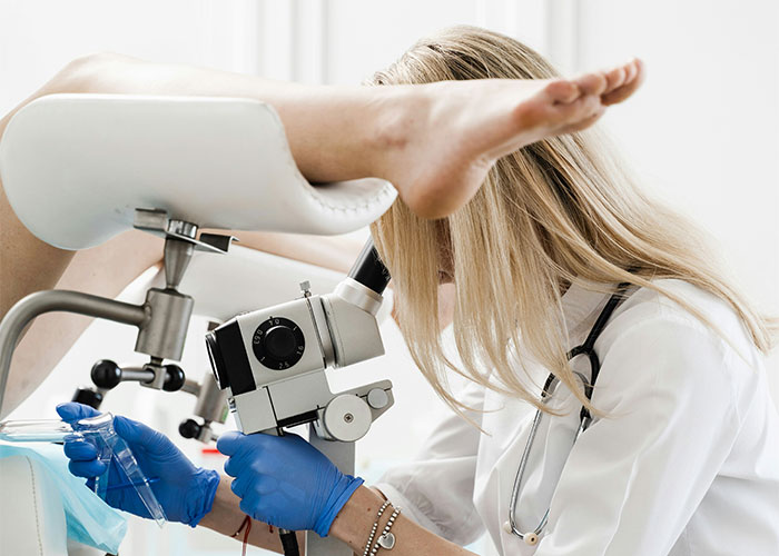 A doctor performing a medical examination in a clinical setting, focusing on healthcare practices.