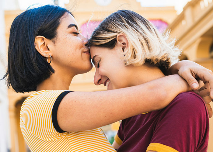 Two people embracing warmly outdoors, highlighting family affection.
