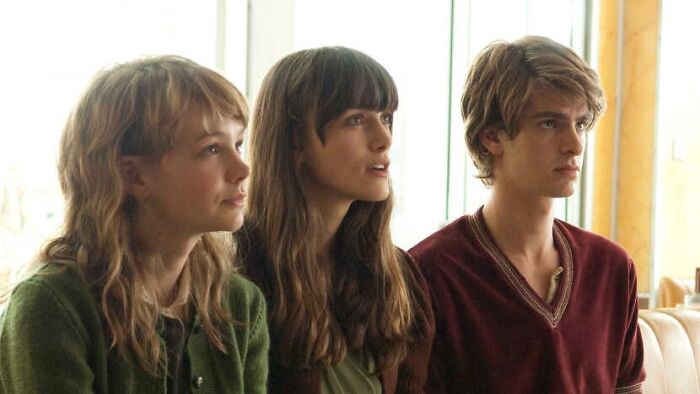 Three young adults in an emotional scene from a tear-jerking movie.