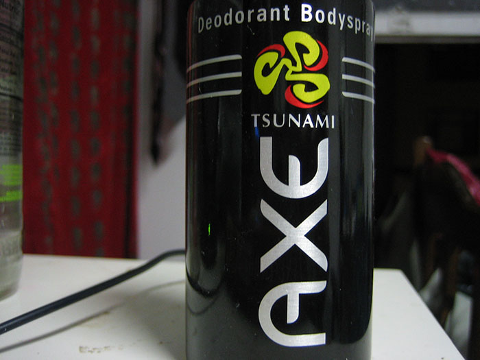Axe deodorant bodyspray can on a shelf, showcasing misleading marketing claims.
