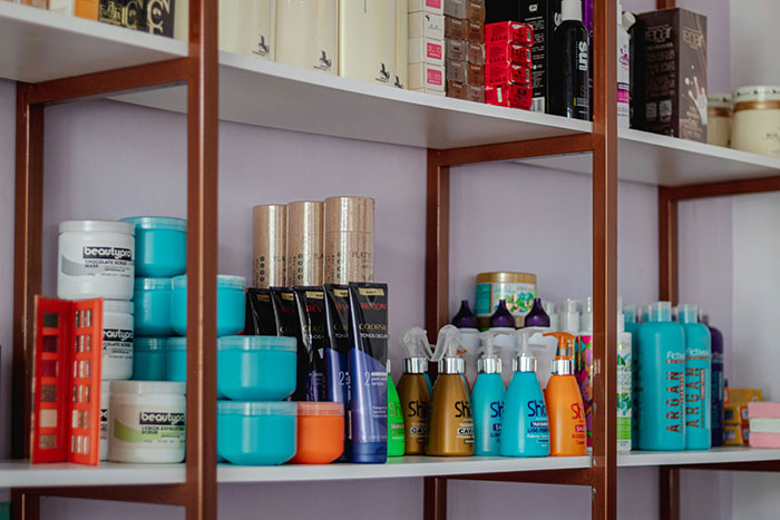 Various beauty products on shelves, showcasing companies’ marketing to sell their products.
