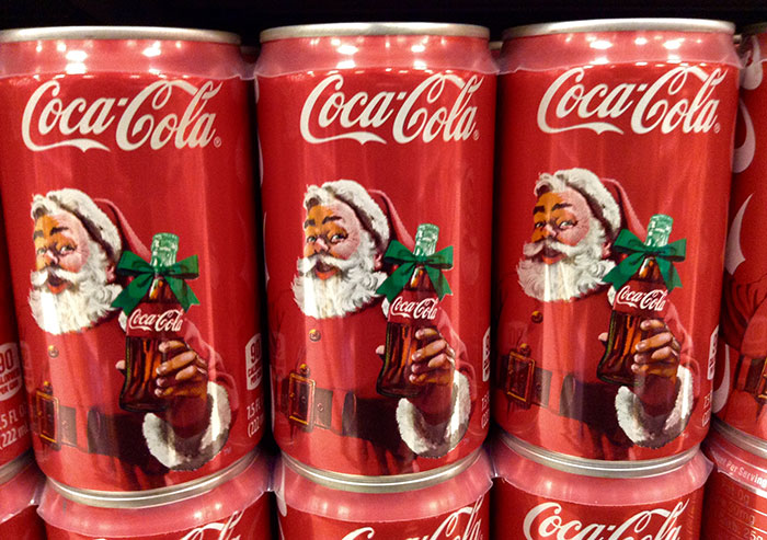 Coca-Cola cans featuring Santa Claus, illustrating marketing techniques in product sales.