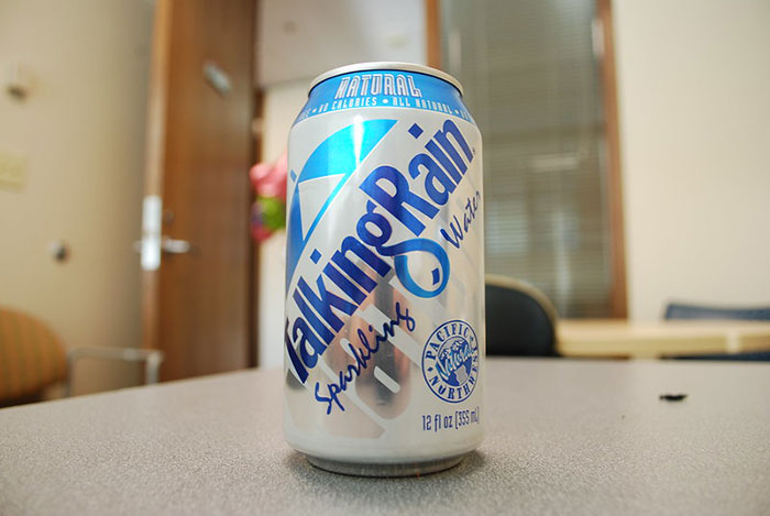 Can of Talking Rain sparkling water on a table, highlighting product packaging in an office setting.