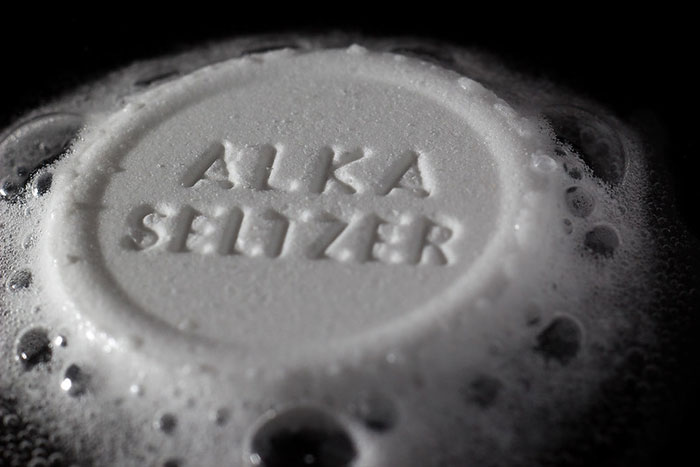 Alka-Seltzer tablet fizzing in water, highlighting deceptive marketing in product sales.