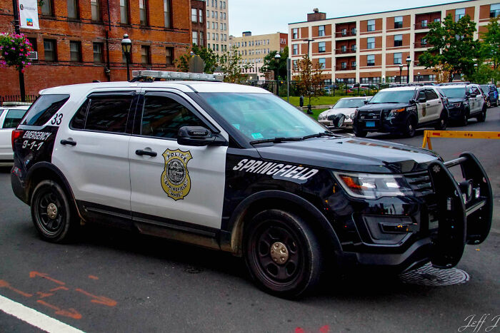 Springfield police SUV on city street amid New England serial horror investigations.