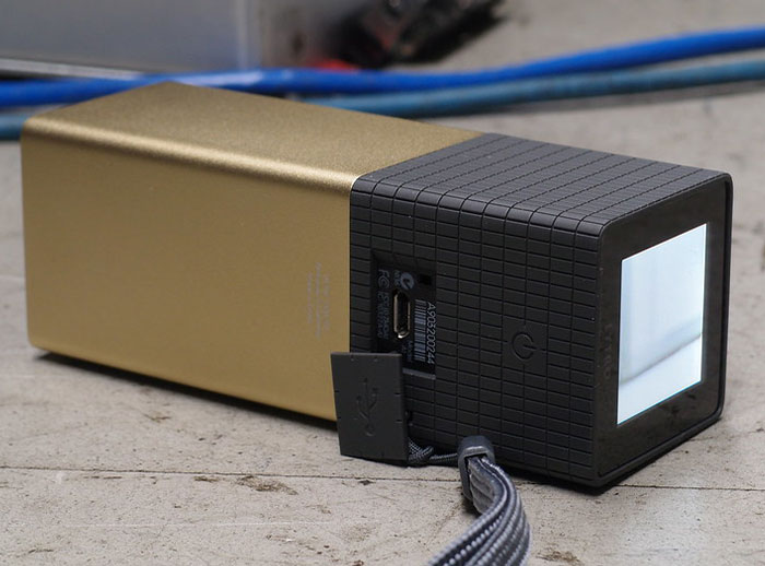 Golden and black Lytro camera, an example of a tech flop on a concrete surface.