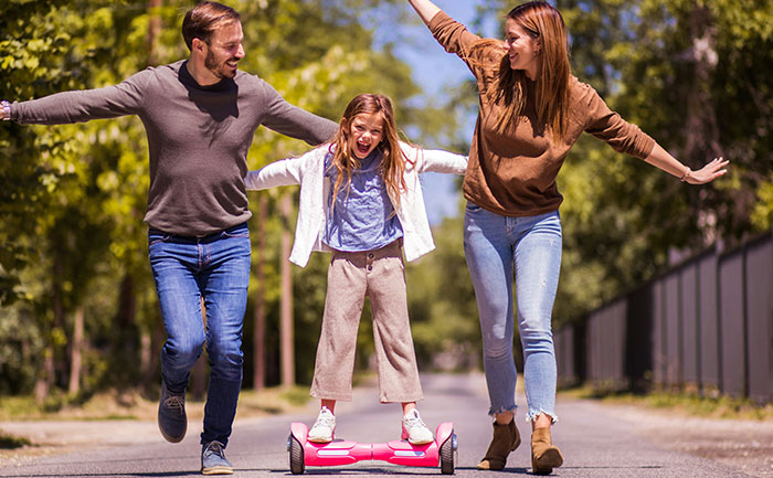 Family enjoying time with a child on a hoverboard, once hyped as the next big thing.