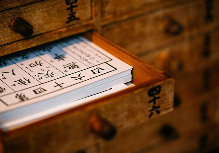 Open wooden drawer with papers featuring Japanese characters; a visual metaphor for a "Next Big Thing" flop.