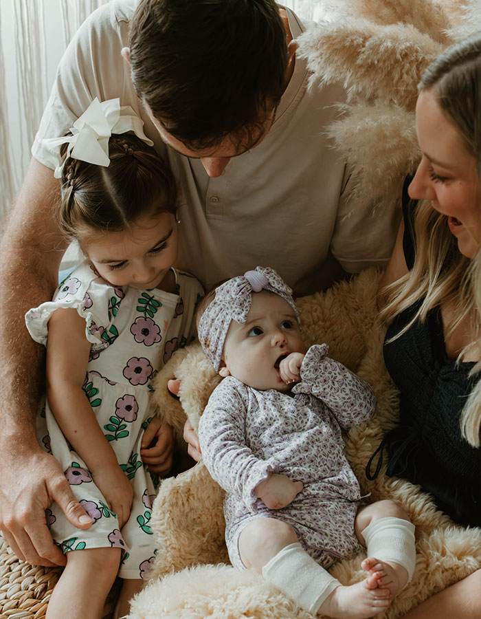 Family embraces baby in emotional moment after influencer's daughter passes away at 10 months.