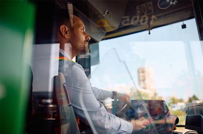 Man driving a bus reflecting on US culture nuances discovered while traveling outside America.