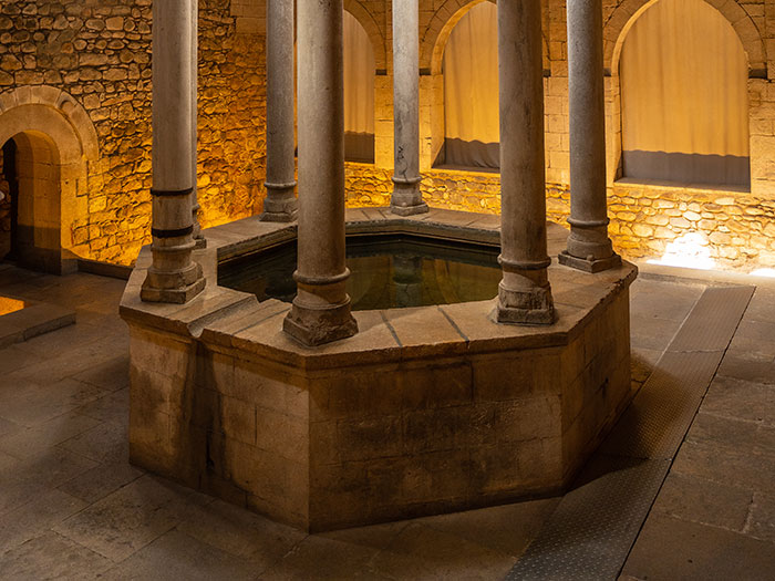 Medieval stone structure with pillars, dimly lit, resembling a historical setting for love potions.