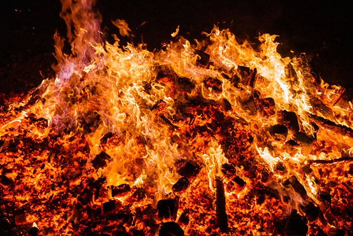 A blazing fire with vibrant flames, reminiscent of medieval times rituals involving love potions.