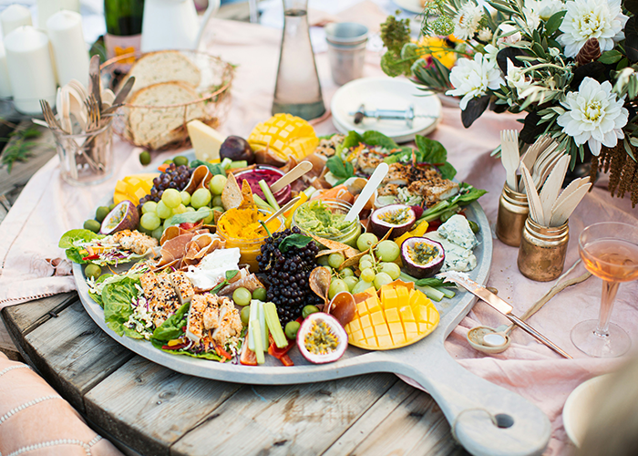 Vegetarian wedding platter with fruits and vegetables arranged on a wooden table, without meat options. Vegetarian wedding platter with fruits and vegetables arranged on a wooden table, without meat options.