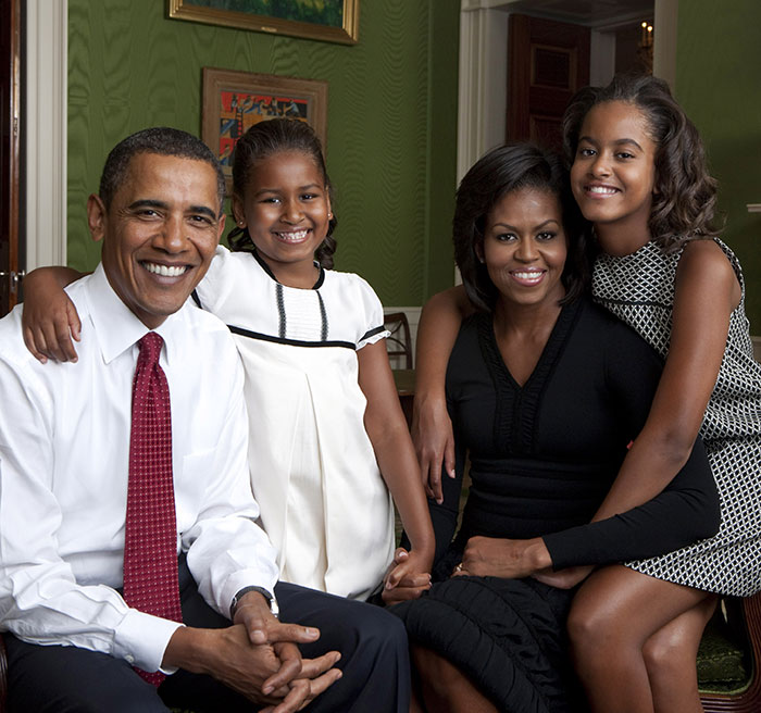 Michelle Obama smiles with family in a room, addressing divorce rumors while showcasing unity and happiness. Michelle Obama smiles with family in a room, addressing divorce rumors while showcasing unity and happiness.